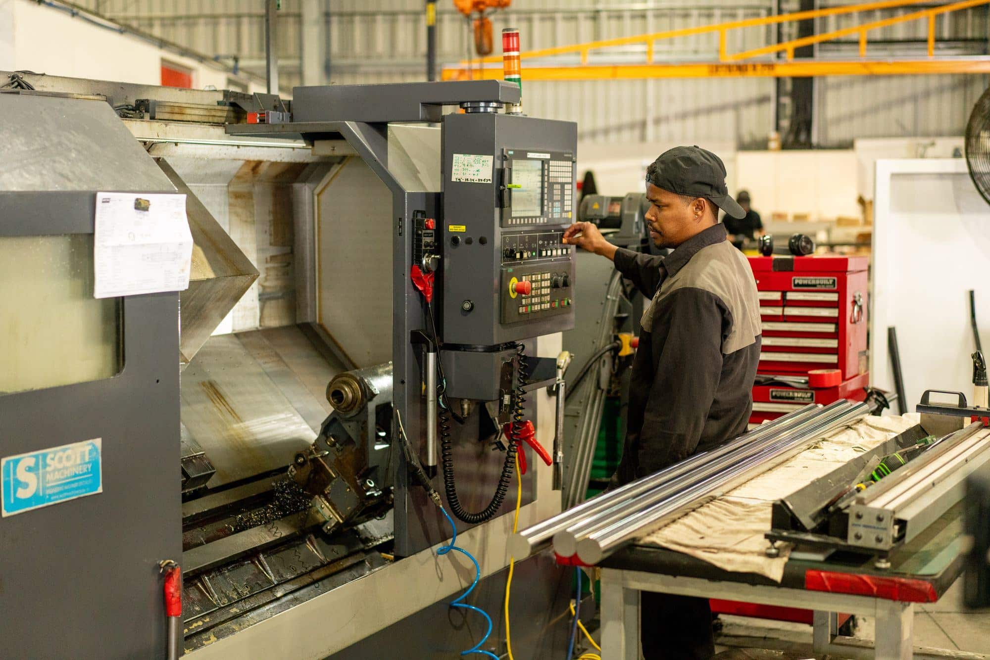 A machinist at a CNC machine in the Motus factory