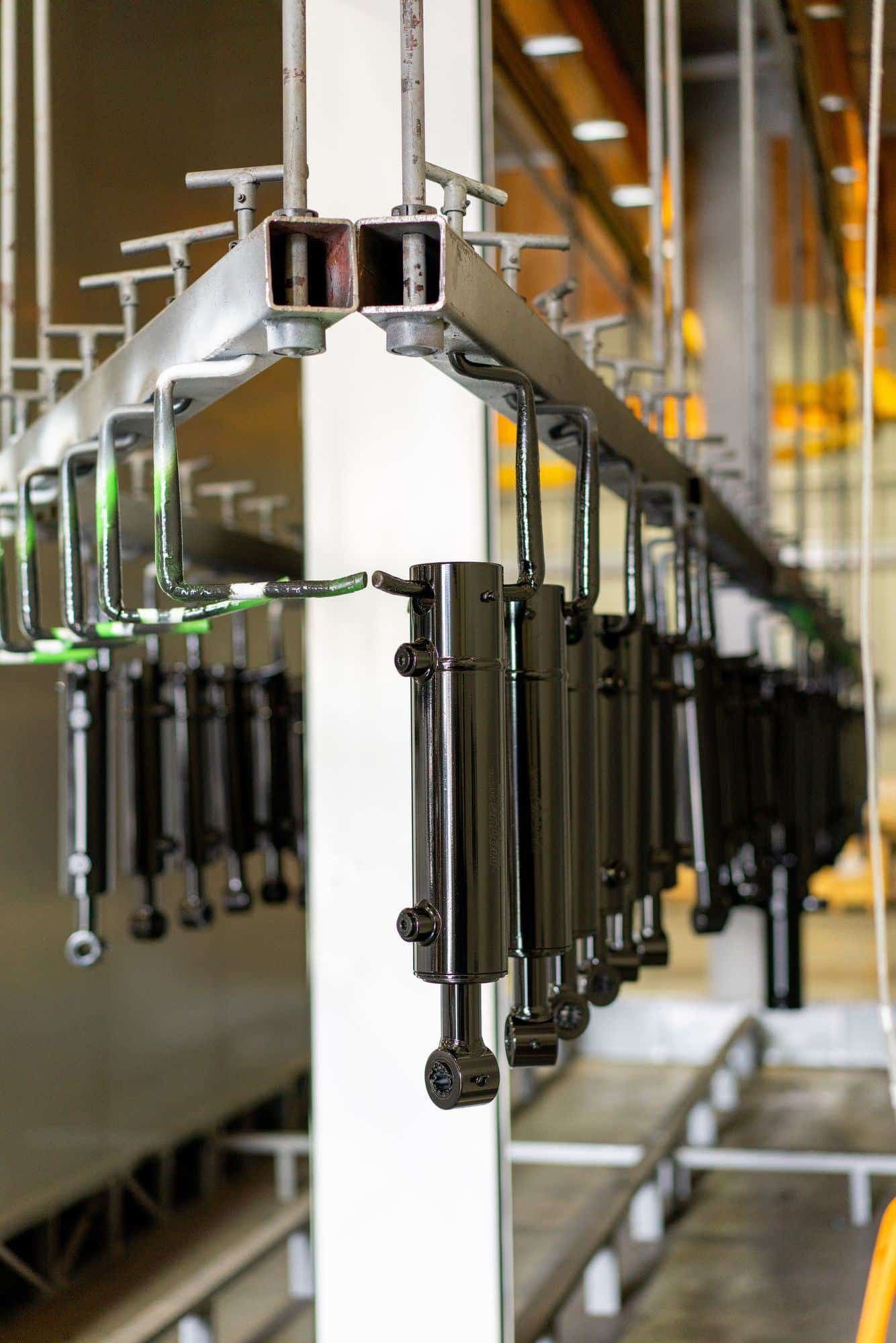 Finished cylinders hanging on the paint line